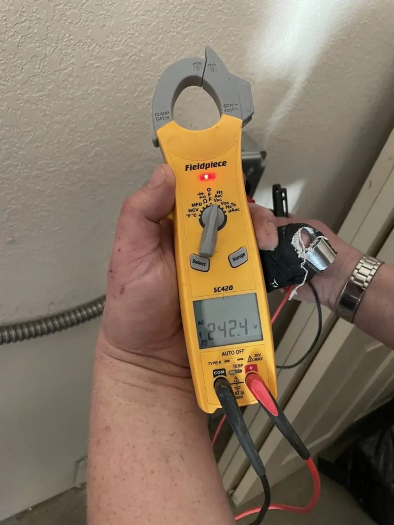 Voltage testing with clamp meter during Whole House Surge Protector in Candlewick Lake
